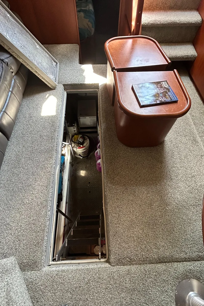 Slide: The Image of Interior of 2004 Silverton 39 Motor Yacht with open engine hatch and table. - 39