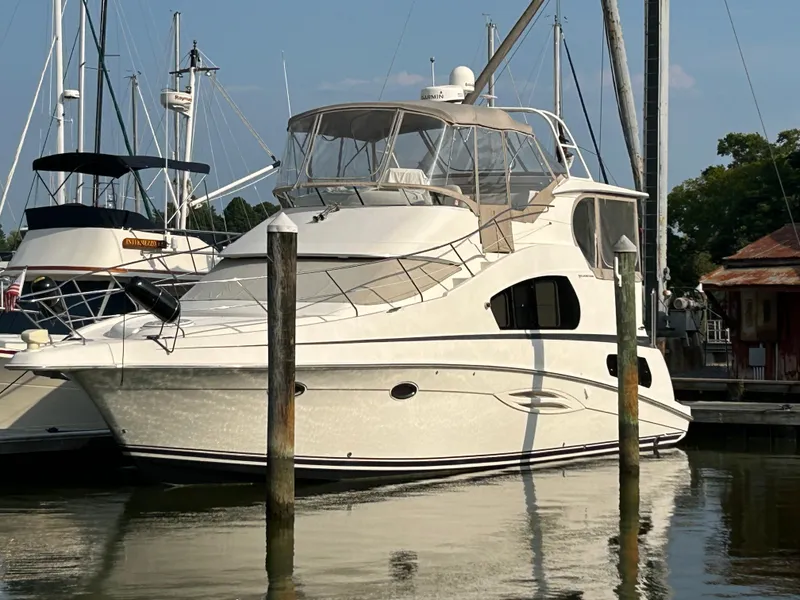Slide: The Image of 2004 Silverton 39 Motor Yacht docked at marina, surrounded by other boats. - 4