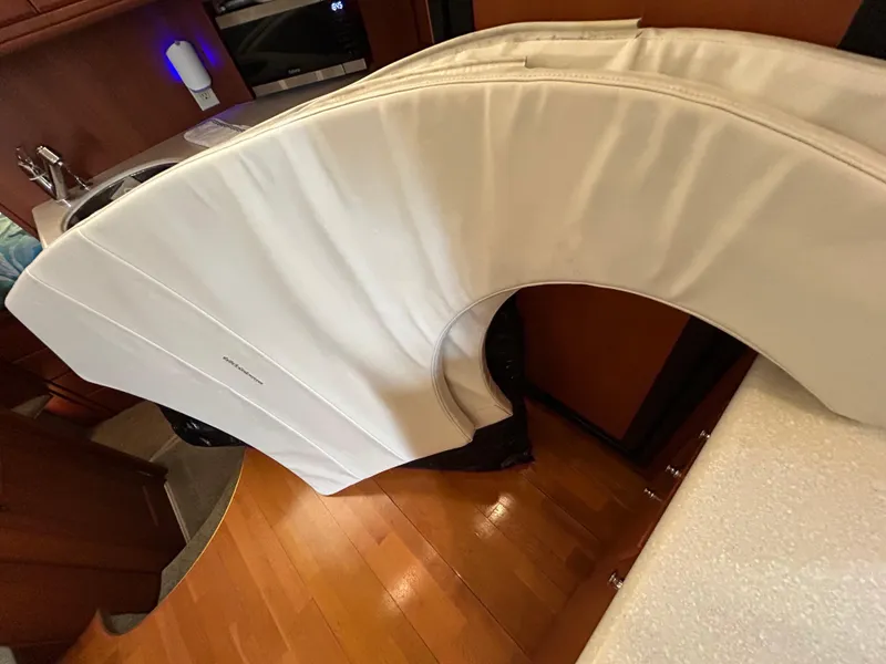 Slide: The Image of 2004 Silverton 39 Motor Yacht interior with white cushioned seating. - 43