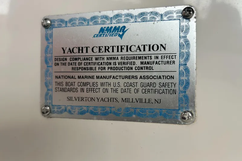 Slide: The Image of 2004 Silverton 39 Motor Yacht certification plaque, NMMA compliance, U.S. Coast Guard safety standards. - 44