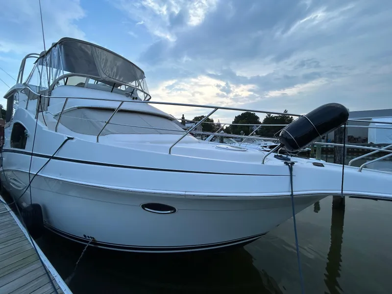 Slide: The Image of 2004 Silverton 39 Motor Yacht docked at marina under cloudy sky. - 5