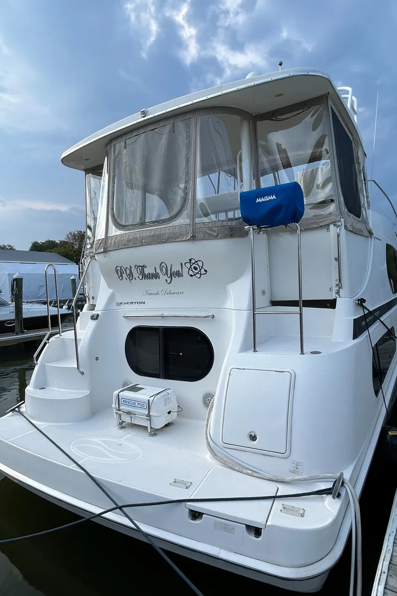 Slide: The Image of 2004 Silverton 39 Motor Yacht docked under cloudy sky. - 8
