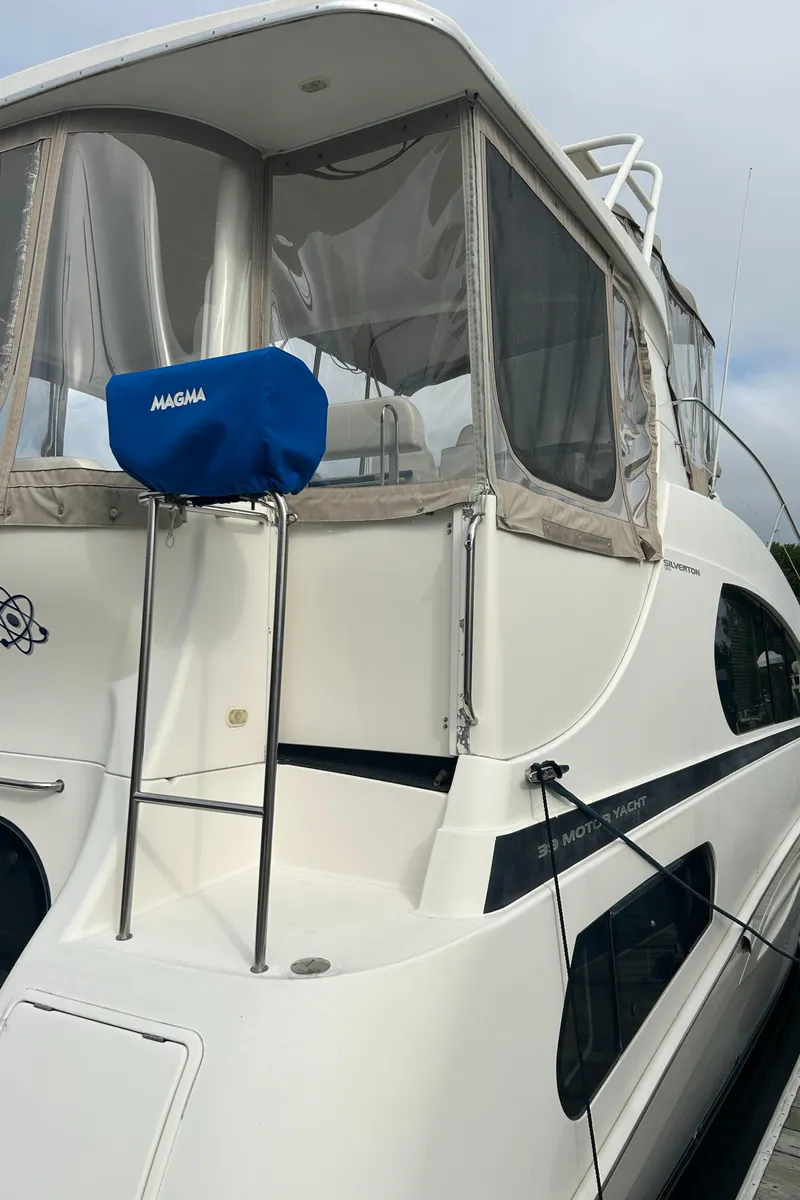 Slide: The Image of 2004 Silverton 39 Motor Yacht with covered seating area and sleek design. - 9