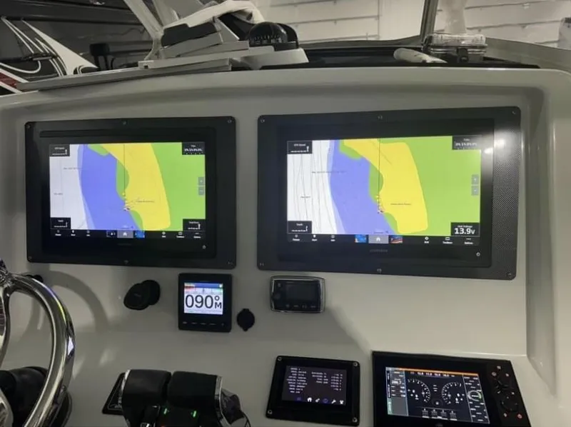 Slide: The Image of 2016 Yellowfin 39 boat dashboard with dual navigation screens and controls. - 12