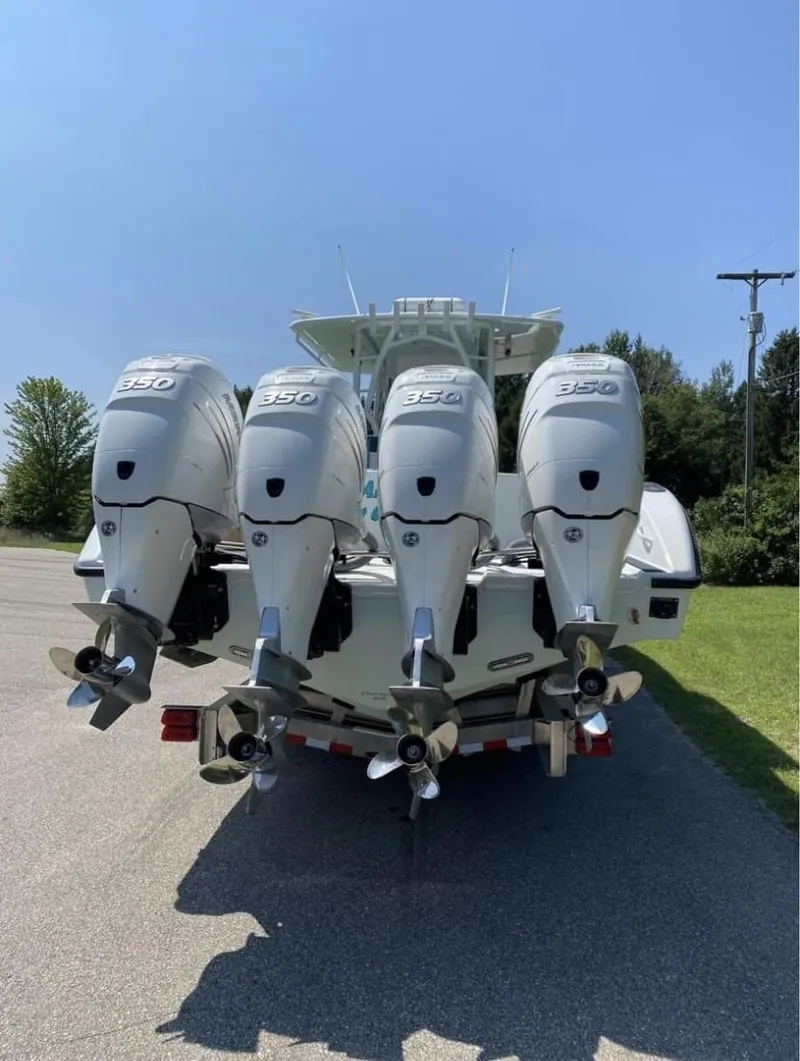 Slide: The Image of 2016 Yellowfin 39 boat with four powerful outboard engines, parked on a sunny day. - 3