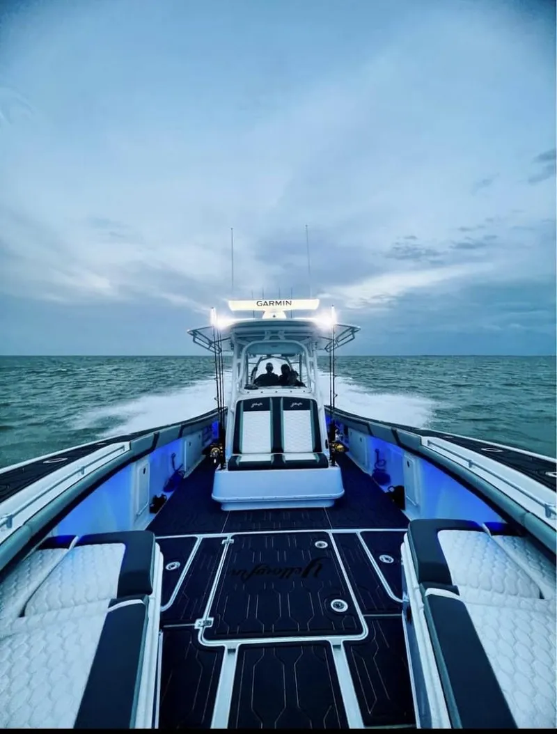 Slide: The Image of 2016 Yellowfin 39 boat cruising on open water at sunset. - 5