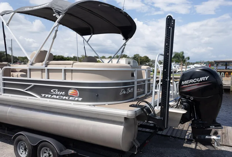 Slide: The Image of 2019 Sun Tracker 24 DLX Party Barge with Mercury outboard motor at dock. - 14