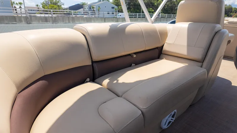 Slide: The Image of 2019 Sun Tracker 24 DLX Party Barge interior seating, beige upholstery, outdoor setting. - 18