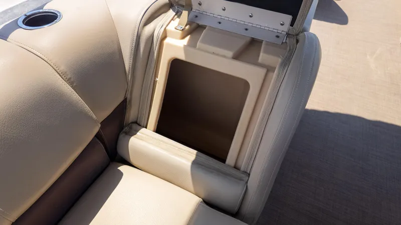 Slide: The Image of Sun Tracker 24 DLX Party Barge 2019 seat storage compartment with cup holder. - 20