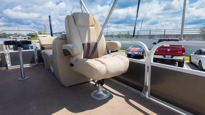 Slide: The Image of 2019 Sun Tracker 24 DLX Party Barge interior with plush seating and table. - 21