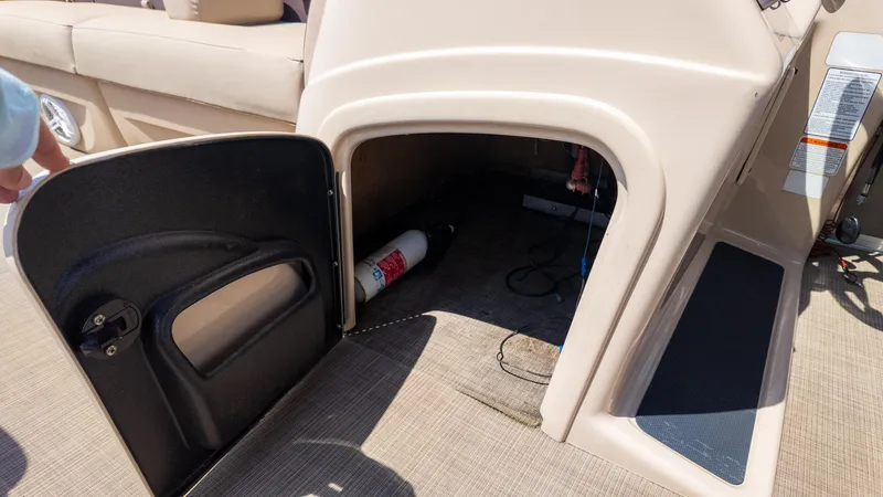 Slide: The Image of Open storage compartment on 2019 Sun Tracker 24 DLX Party Barge boat. - 25