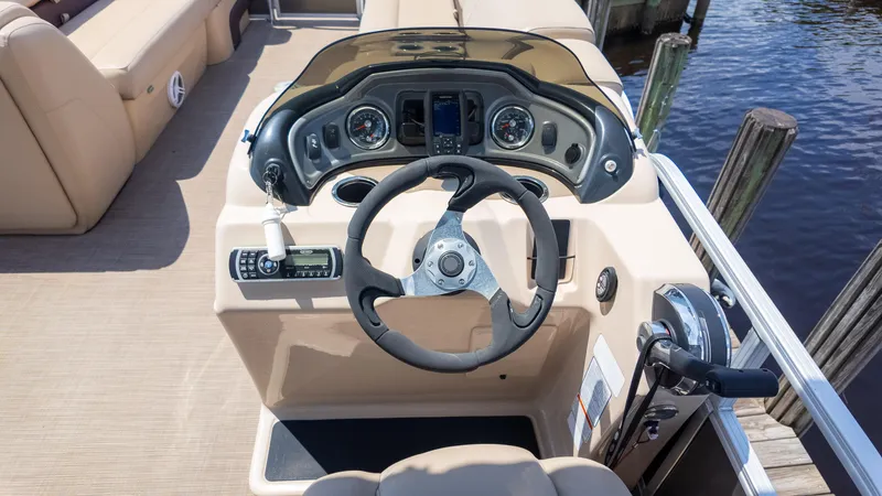 Slide: The Image of 2019 Sun Tracker 24 DLX Party Barge helm with steering wheel and controls. - 26