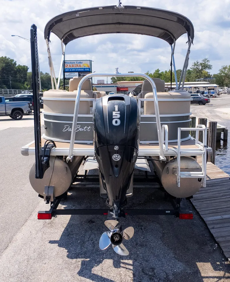 Slide: The Image of 2019 Sun Tracker 24 DLX Party Barge with 150 HP engine at marina dock. - 3