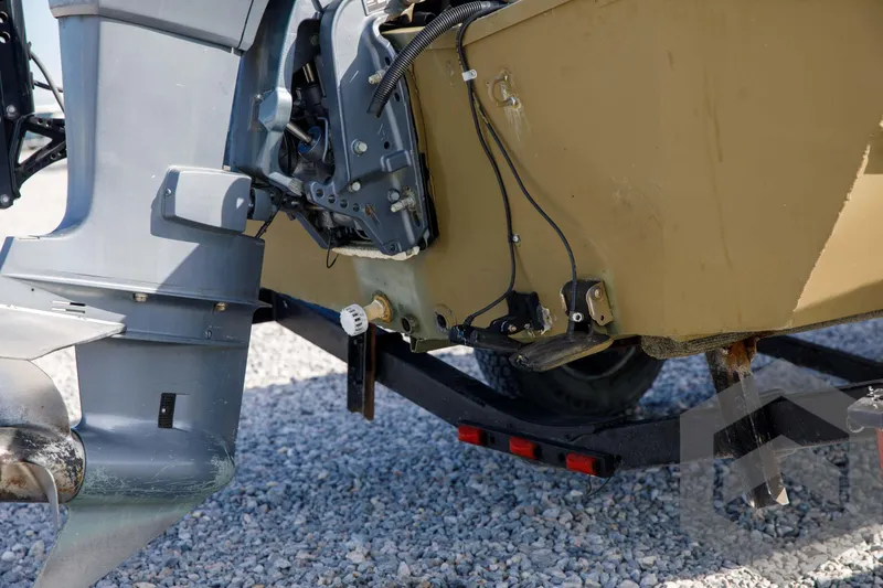 Slide: The Image of 2003 Polar Kraft Sportsman MV1885CC boat motor and trailer on gravel. - 12