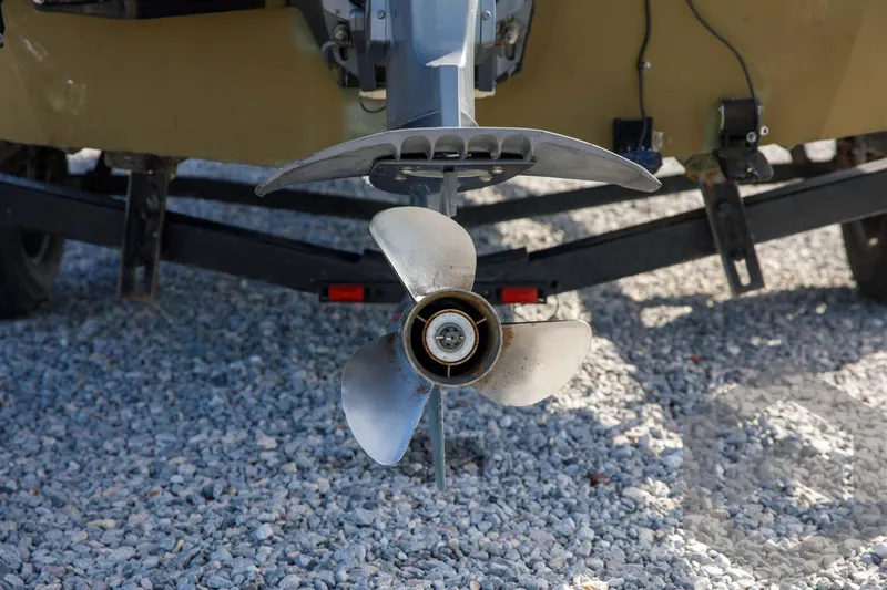 Slide: The Image of 2003 Polar Kraft Sportsman MV1885CC boat propeller on gravel surface. - 13