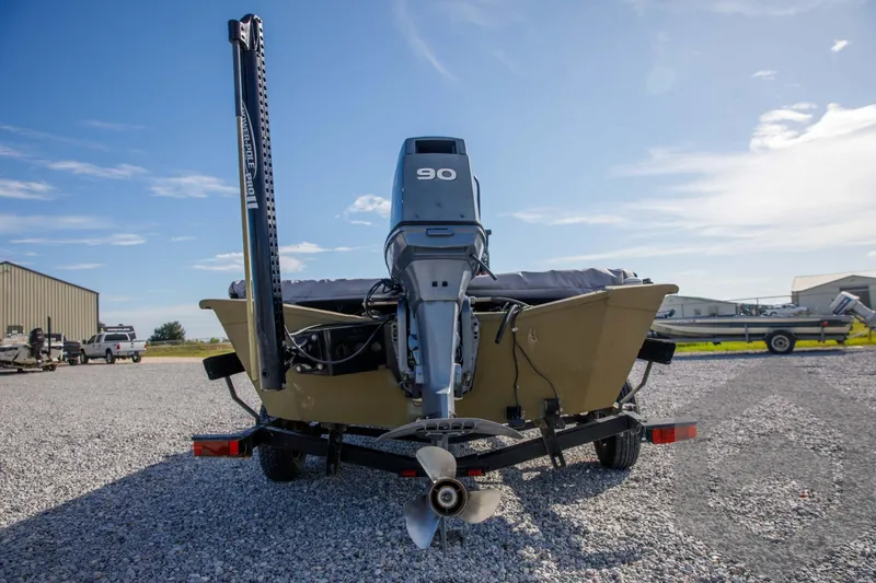 Slide: The Image of 2003 Polar Kraft Sportsman MV1885CC boat with outboard motor on gravel lot. - 14