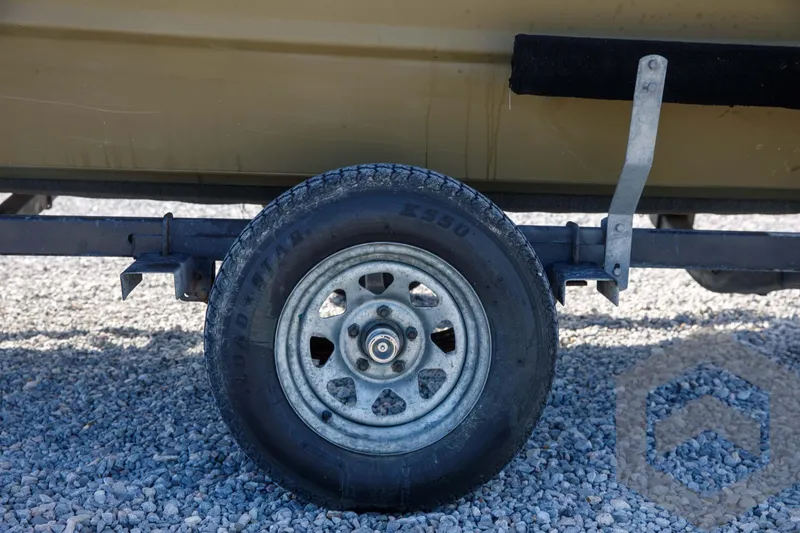 Slide: The Image of Trailer wheel of 2003 Polar Kraft Sportsman MV1885CC on gravel surface. - 17