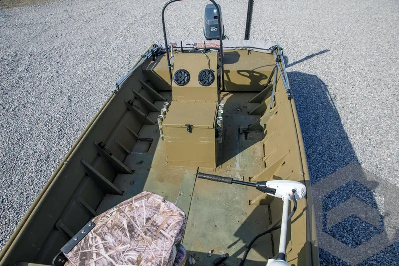 Slide: The Image of 2003 Polar Kraft Sportsman MV1885CC boat interior with camouflage seat and steering console. - 21