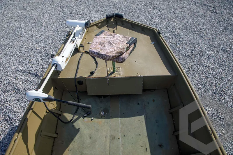 Slide: The Image of 2003 Polar Kraft Sportsman MV1885CC boat interior with camouflage seat and trolling motor. - 22