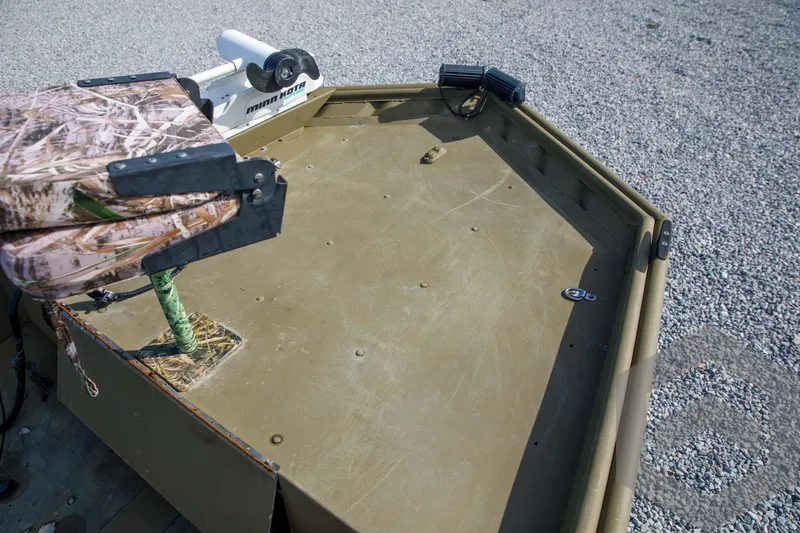 Slide: The Image of 2003 Polar Kraft Sportsman MV1885CC boat deck with camouflage seat and motor. - 23