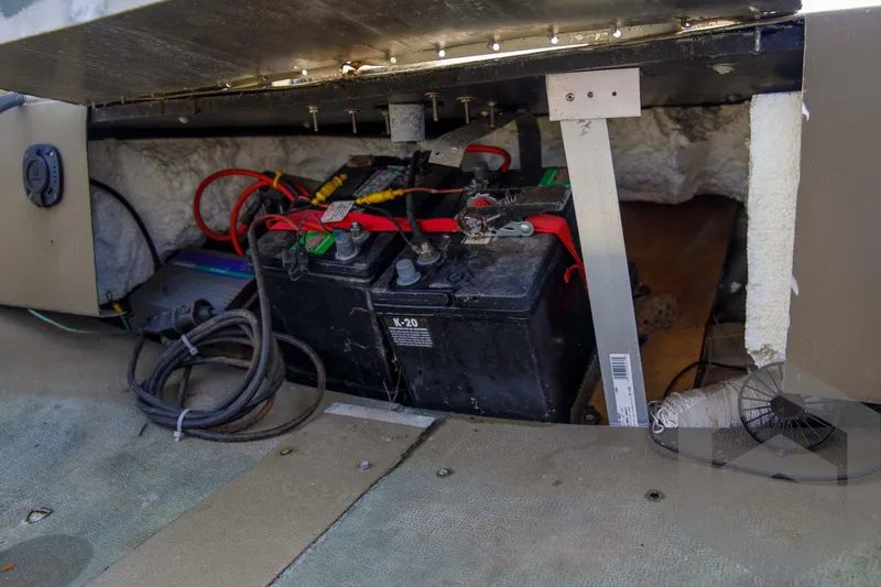 Slide: The Image of 2003 Polar Kraft Sportsman MV1885CC boat battery compartment with wiring and cables. - 26