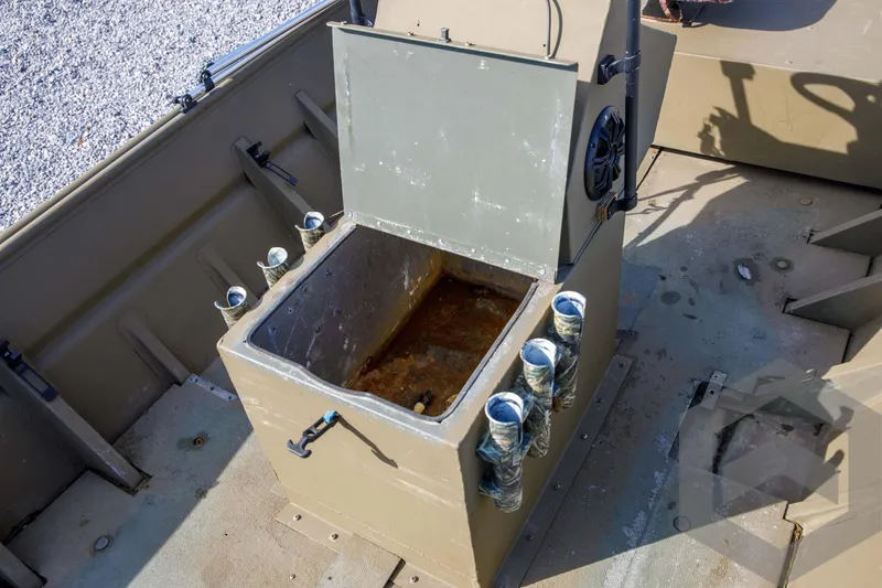 Slide: The Image of 2003 Polar Kraft Sportsman MV1885CC boat interior with open storage compartment and rod holders. - 27