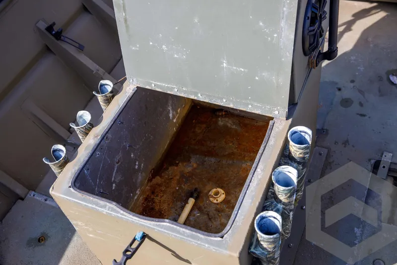 Slide: The Image of Open storage compartment on 2003 Polar Kraft Sportsman MV1885CC boat with rod holders. - 28