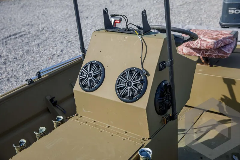 Slide: The Image of 2003 Polar Kraft Sportsman MV1885CC boat console with speakers and steering wheel. - 30