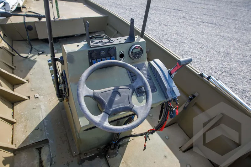 Slide: The Image of 2003 Polar Kraft Sportsman MV1885CC boat steering console with controls and gauges. - 31