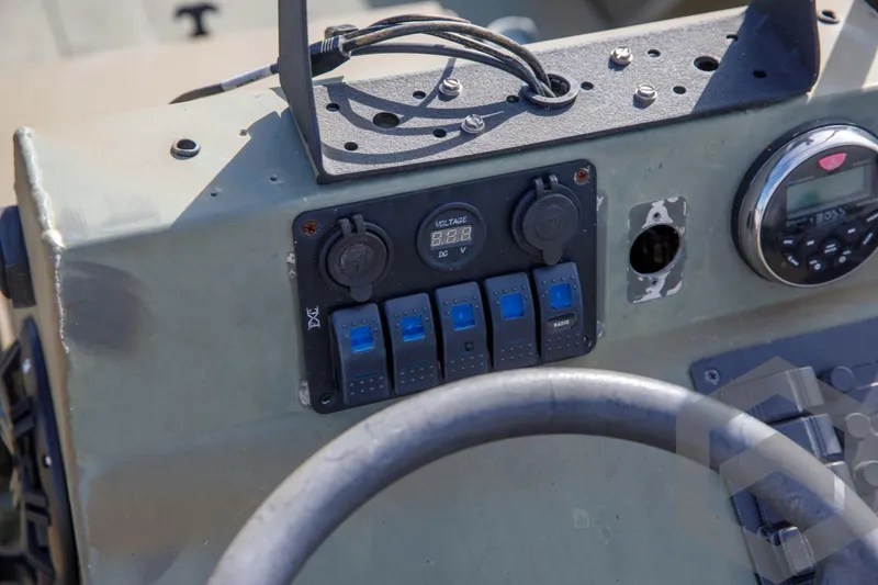 Slide: The Image of Control panel of 2003 Polar Kraft Sportsman MV1885CC boat with switches and gauges. - 32