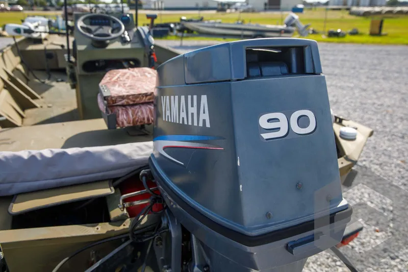 Slide: The Image of 2003 Polar Kraft Sportsman MV1885CC with Yamaha 90 outboard motor, parked on gravel. - 38