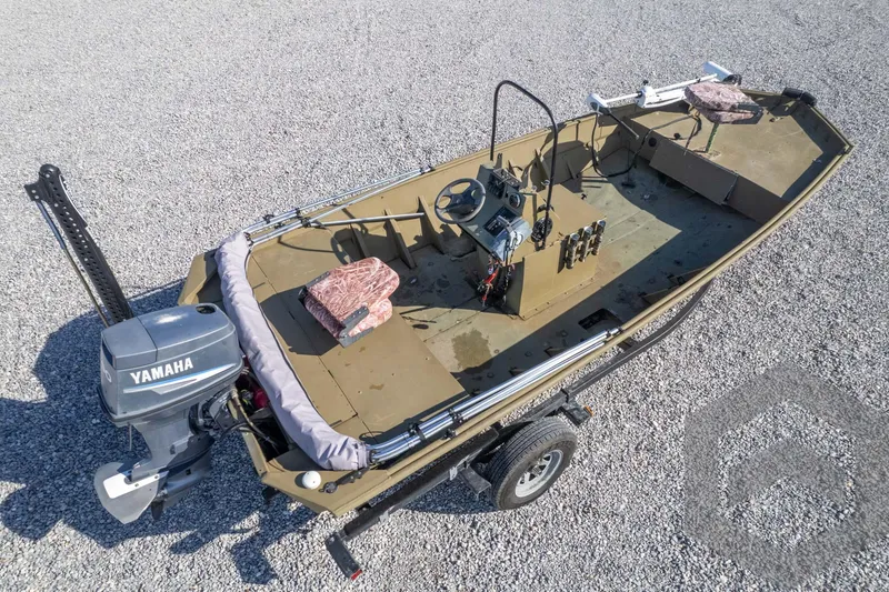 Slide: The Image of 2003 Polar Kraft Sportsman MV1885CC boat with Yamaha motor on gravel surface. - 49