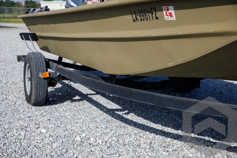 Slide: The Image of 2003 Polar Kraft Sportsman MV1885CC boat on trailer, parked on gravel. - 9
