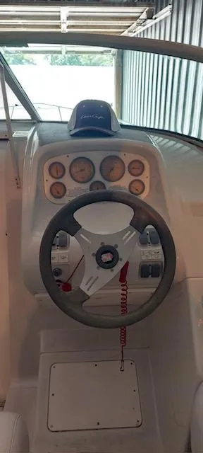 Slide: The Image of 1993 Chris-Craft Select Cuddy boat dashboard with steering wheel and gauges. - 10