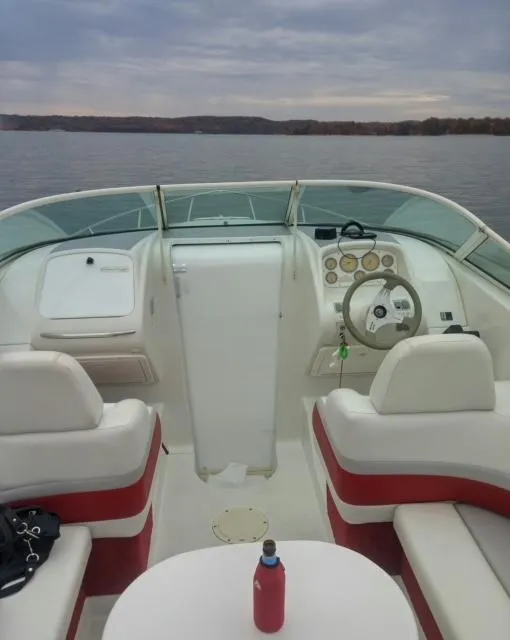 Slide: The Image of 1993 Chris-Craft Select Cuddy boat interior with lake view, featuring white and red seating. - 13