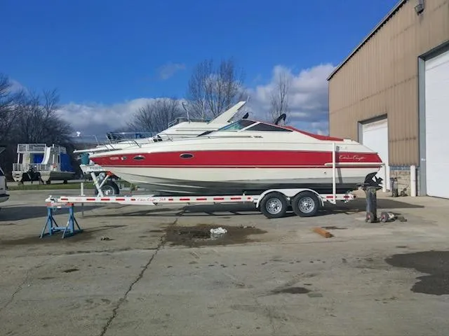 Slide: The Image of 1993 Chris-Craft Select Cuddy boat on trailer near warehouse. - 2