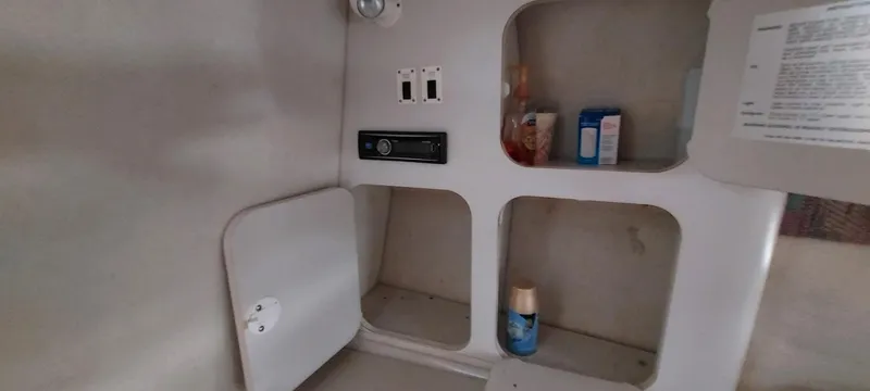 Slide: The Image of Interior storage compartments in a 1993 Chris-Craft Select Cuddy boat. - 8