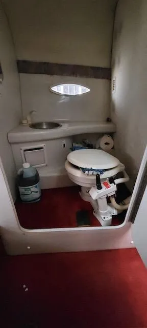Slide: The Image of 1993 Chris-Craft Select Cuddy boat bathroom with toilet and sink. - 9
