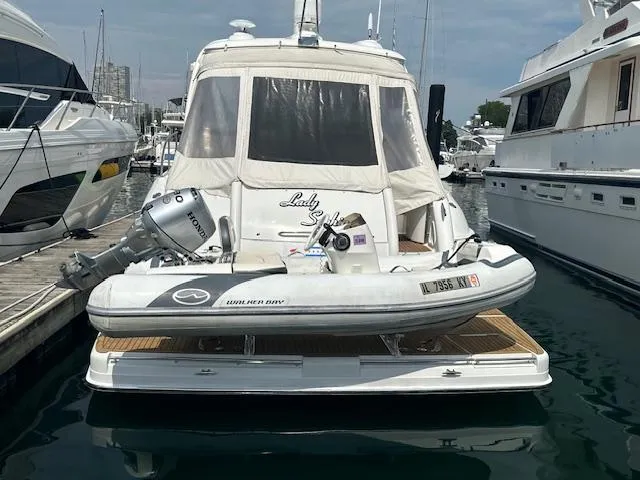 The Image of 2019 Walker Bay Generation 11 LTE boat docked at marina, rear view. - 0
