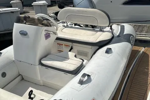 Slide: The Image of 2019 Walker Bay Generation 11 LTE inflatable boat docked at marina. - 2