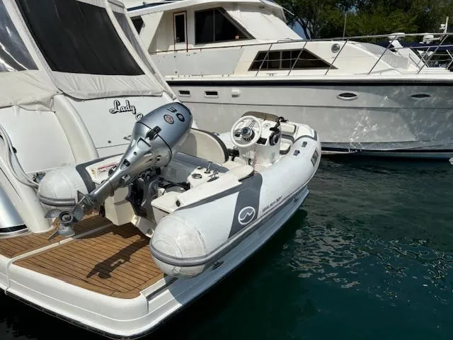 Slide: The Image of 2019 Walker Bay Generation 11 LTE inflatable boat docked beside a yacht. - 8