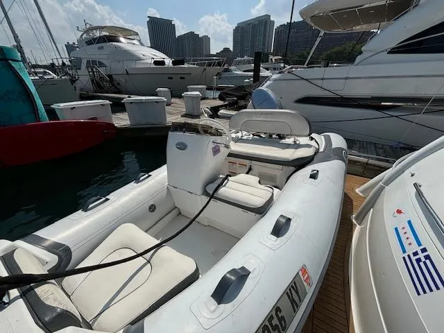 Slide: The Image of 2019 Walker Bay Generation 11 LTE inflatable boat docked at marina with yachts. - 9