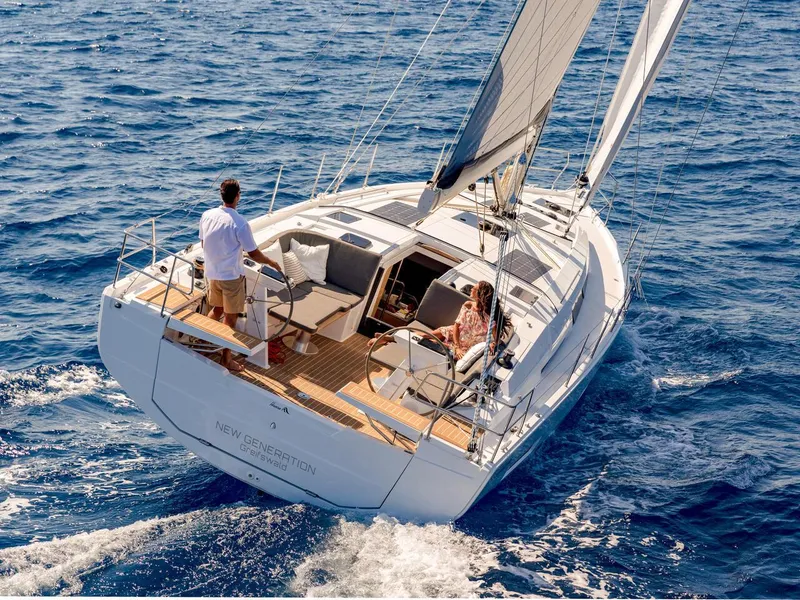 Slide: The Image of 2025 Hanse 410 sailboat cruising on open sea with two people onboard. - 43