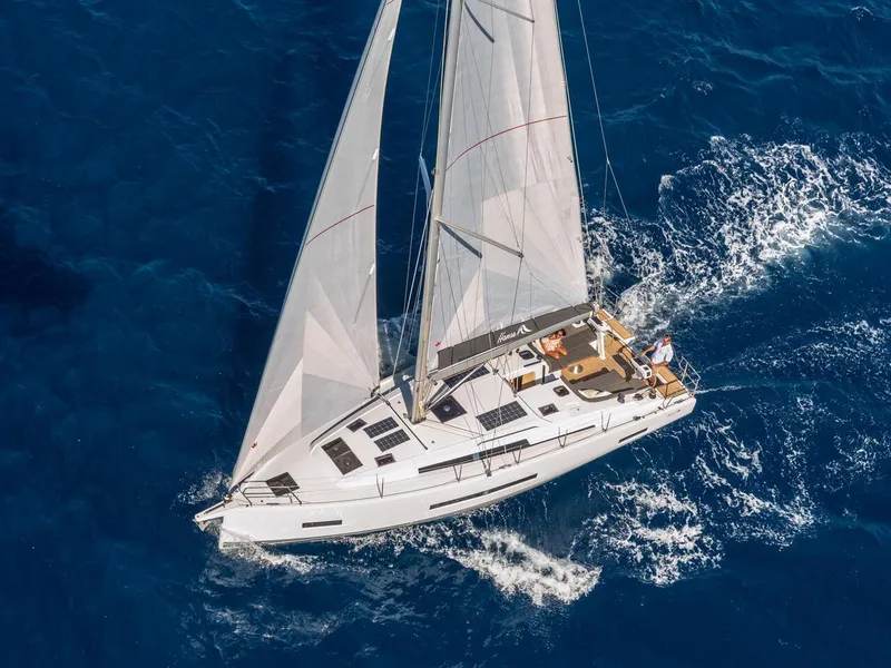 Slide: The Image of Aerial view of 2025 Hanse 410 sailboat navigating blue ocean waters. - 45