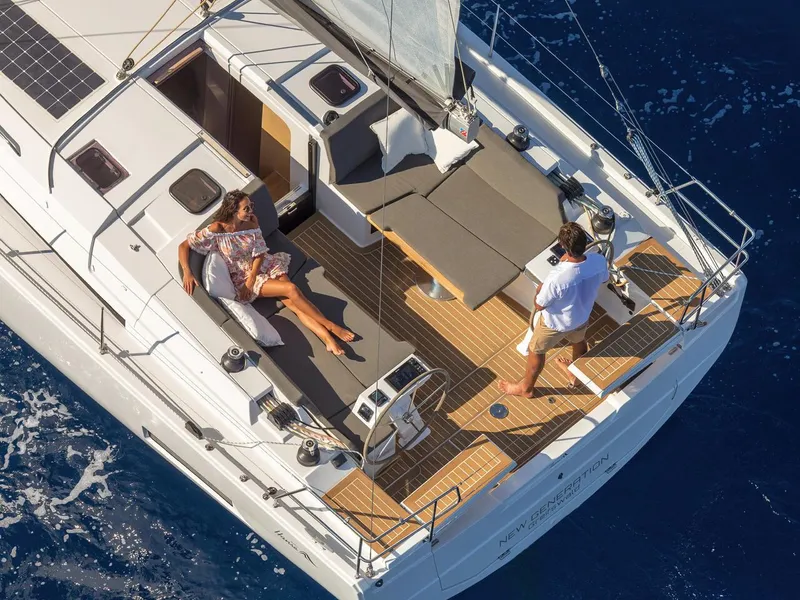 Slide: The Image of Aerial view of 2025 Hanse 410 yacht with people relaxing on deck. - 1