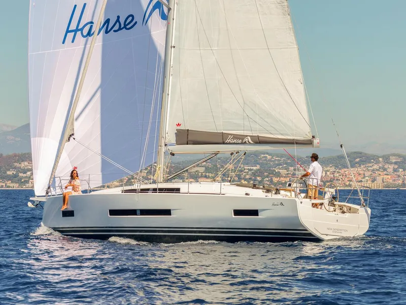 Slide: The Image of 2025 Hanse 410 sailboat cruising on open water with two people onboard. - 11