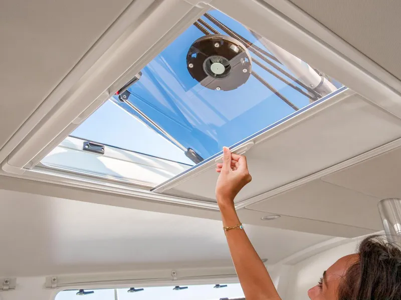 Slide: The Image of Person opening hatch on 2025 Hanse 410 yacht, view of sky and rigging. - 21