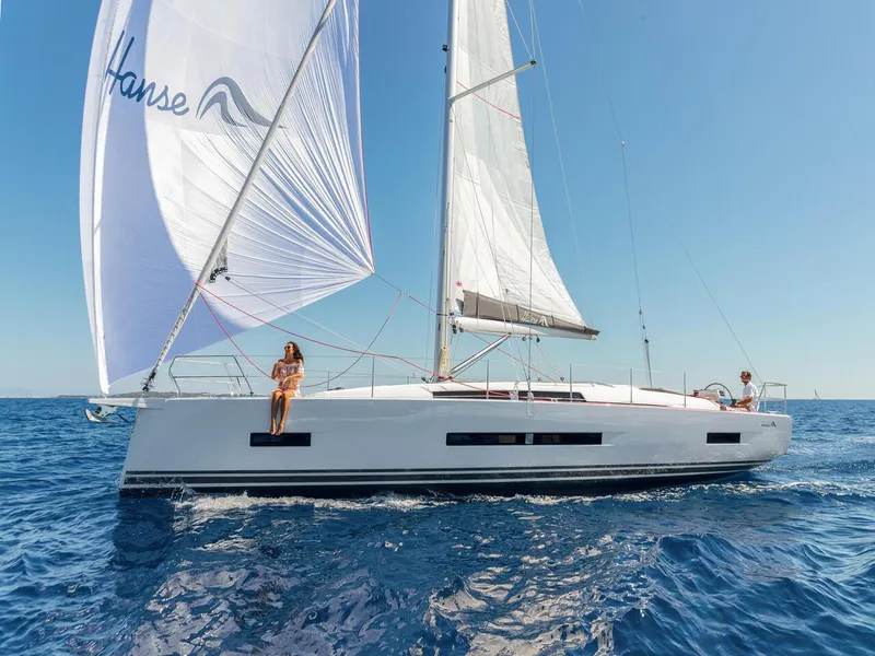Slide: The Image of 2025 Hanse 410 sailboat cruising on open sea under clear blue sky. - 28
