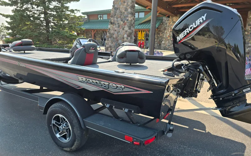Slide: The Image of 2024 Ranger RT188 boat with Mercury engine, parked outdoors. - 2
