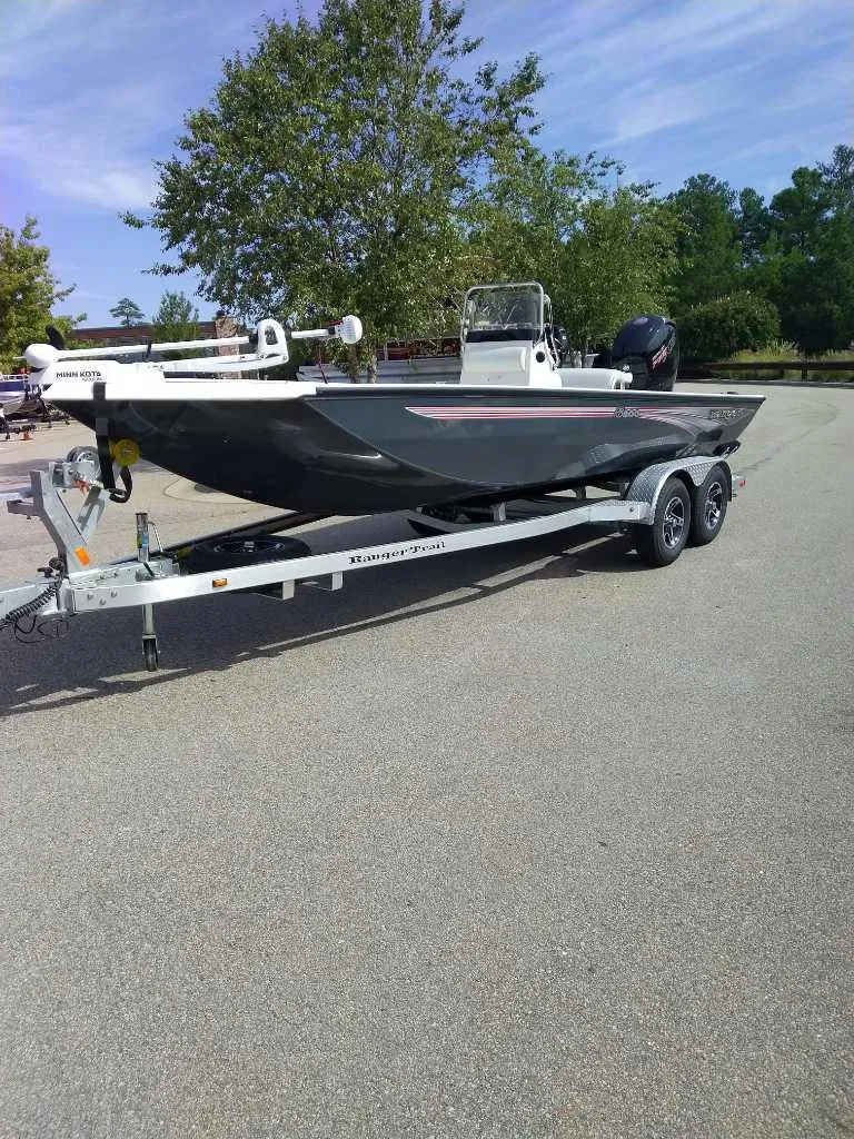 Slide: The Image of 2024 Ranger RB200 boat on trailer, parked outdoors. - 2